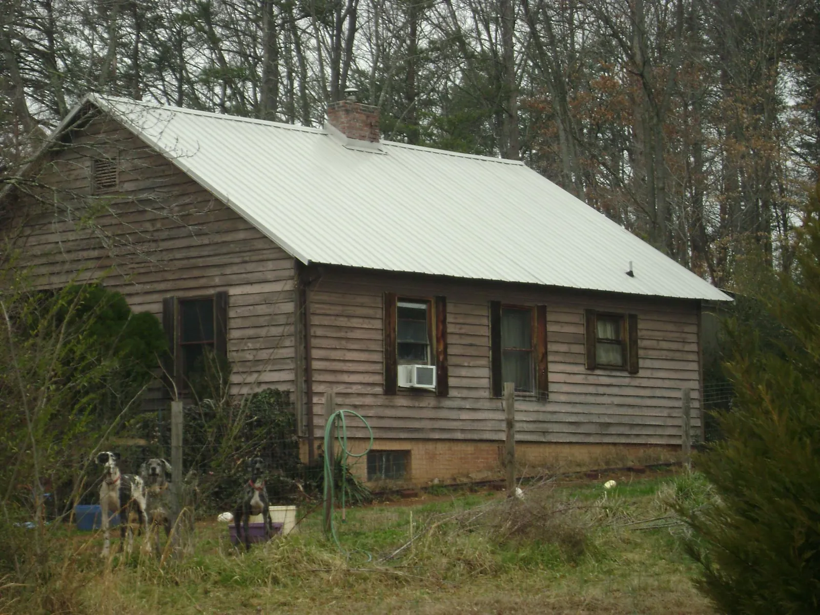 White metal roof on an old wood sided farmhouse, from a Metal Roof Installation job in Farragut